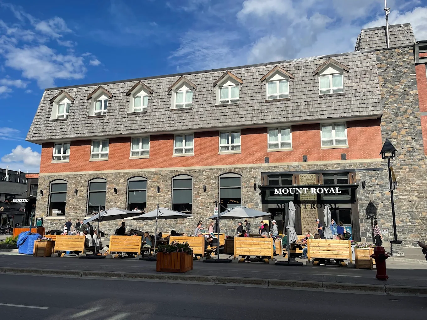 Mount Royal Hotel storefront on Banff Avenue with outdoor patio seating